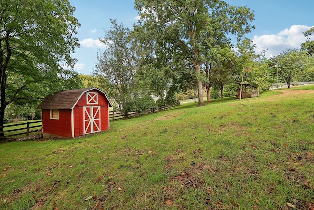 view of yard with a rural view and a storage shed