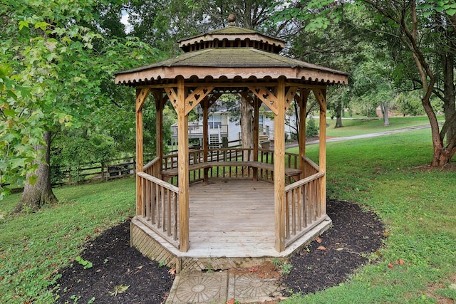 wooden terrace featuring a yard