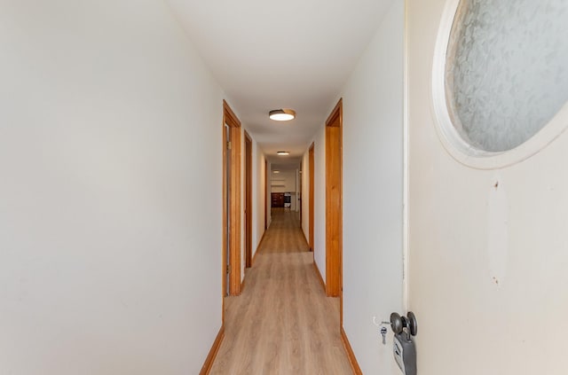 corridor with light hardwood / wood-style flooring