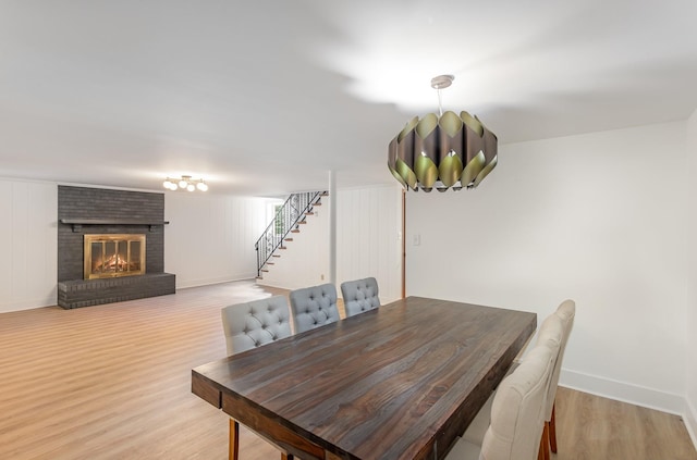 dining room featuring a fireplace and light hardwood / wood-style floors