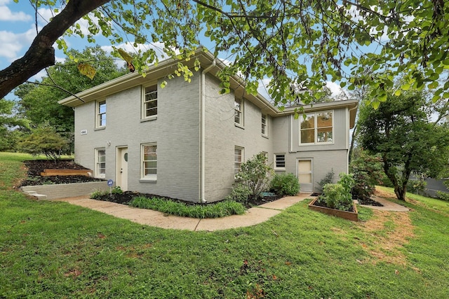 back of house featuring a yard