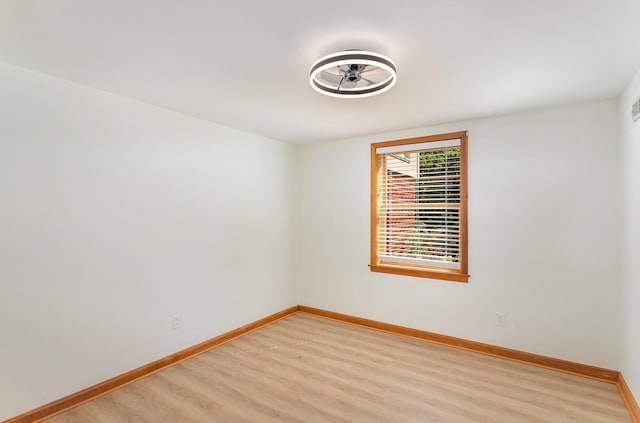 empty room with light hardwood / wood-style flooring