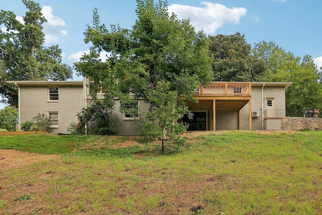 back of property featuring a lawn and a deck