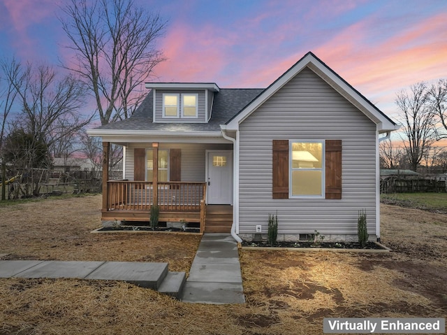 bungalow featuring a porch and roof with shingles