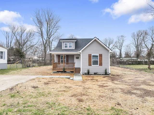 bungalow featuring covered porch, a shingled roof, and fence