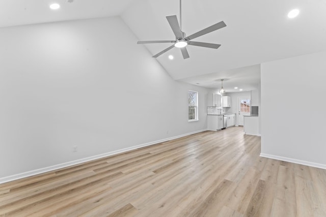 unfurnished living room featuring ceiling fan, baseboards, lofted ceiling, and light wood-style floors