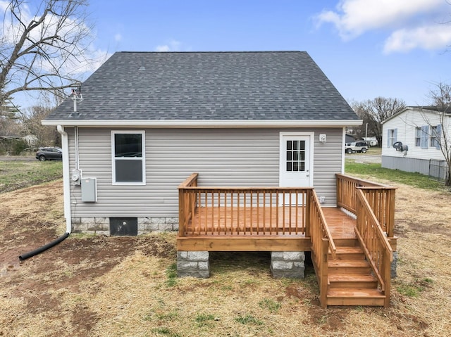 rear view of property featuring a deck and roof with shingles