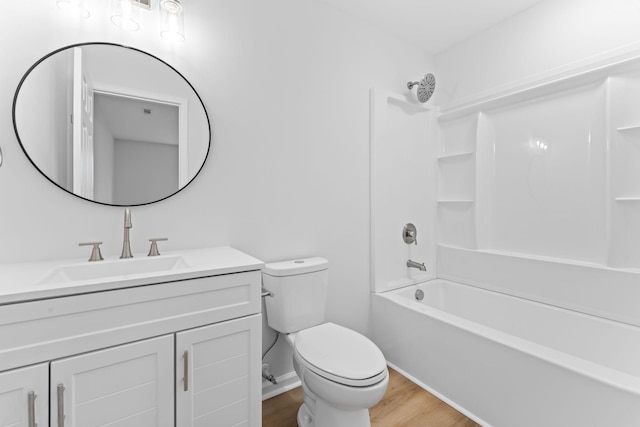 bathroom with shower / bathing tub combination, toilet, vanity, wood finished floors, and baseboards