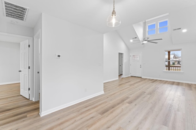 interior space with lofted ceiling, visible vents, and light wood-style floors