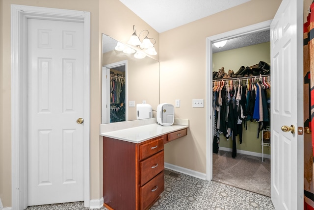 bathroom with a textured ceiling and vanity