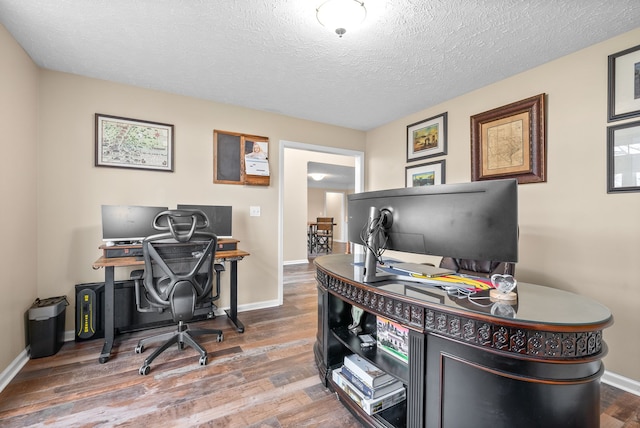 office area with hardwood / wood-style flooring and a textured ceiling