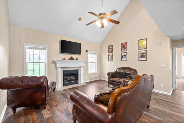 living room with high vaulted ceiling, ceiling fan, and dark wood-type flooring