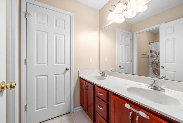 bathroom featuring tile patterned flooring, vanity, and an inviting chandelier