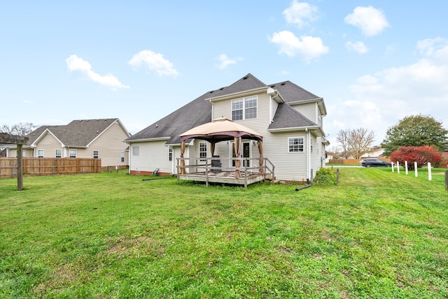 rear view of property featuring a gazebo, a yard, and a wooden deck