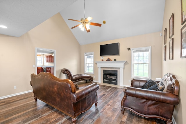 living room featuring plenty of natural light, ceiling fan, dark hardwood / wood-style flooring, and high vaulted ceiling