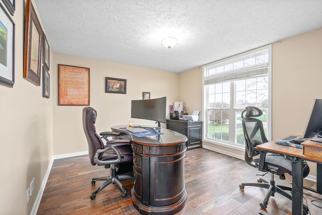 office area featuring a textured ceiling and dark hardwood / wood-style floors