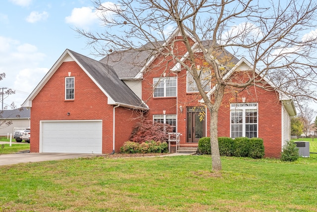 view of front of property featuring a front lawn and a garage