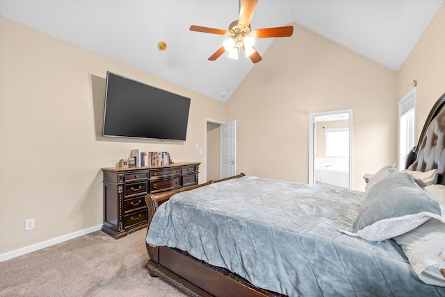 carpeted bedroom with ceiling fan, high vaulted ceiling, and ensuite bath