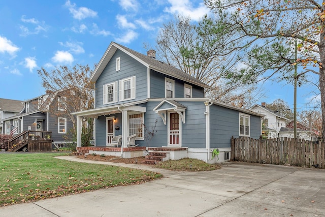 view of front facade with covered porch and a front yard