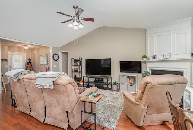 living room featuring ceiling fan, light hardwood / wood-style floors, and vaulted ceiling