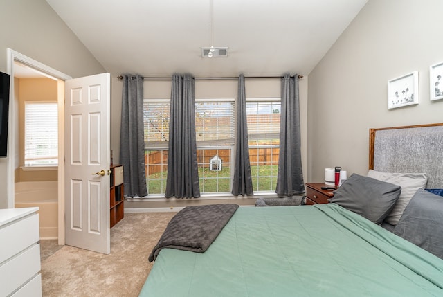 carpeted bedroom with vaulted ceiling and multiple windows