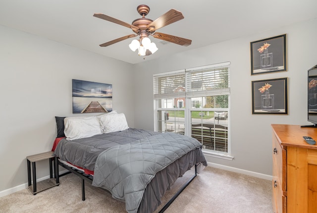 bedroom with ceiling fan and light colored carpet