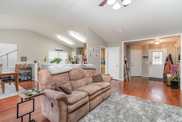 living room with dark hardwood / wood-style flooring, ceiling fan, and lofted ceiling