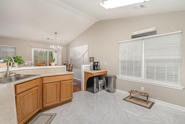 kitchen featuring decorative light fixtures, lofted ceiling, sink, and an inviting chandelier