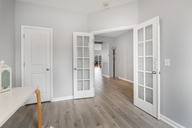 unfurnished dining area featuring light hardwood / wood-style flooring and french doors