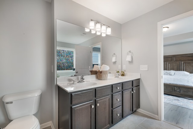 bathroom featuring tile patterned flooring, vanity, and toilet