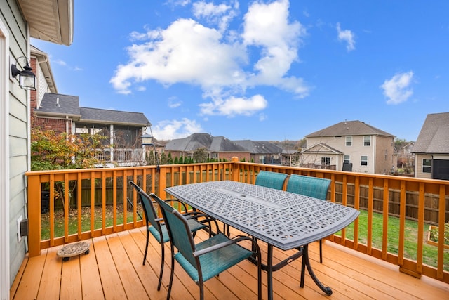 wooden terrace featuring a lawn