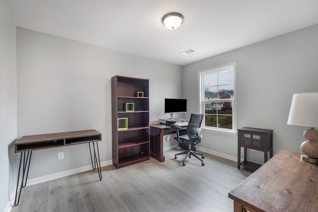 office space with light hardwood / wood-style flooring