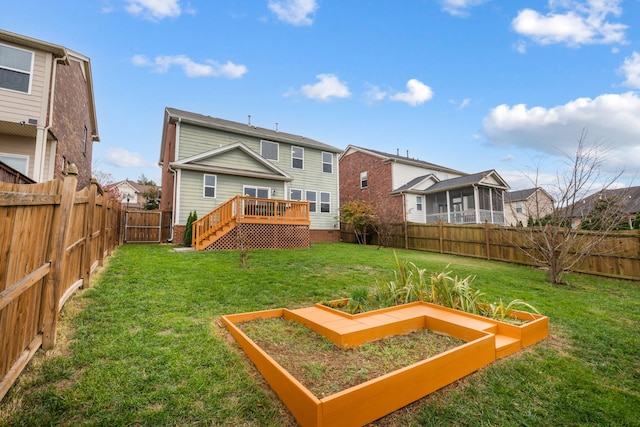 rear view of house with a yard and a wooden deck