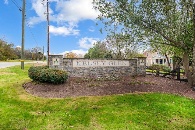 community / neighborhood sign with a lawn