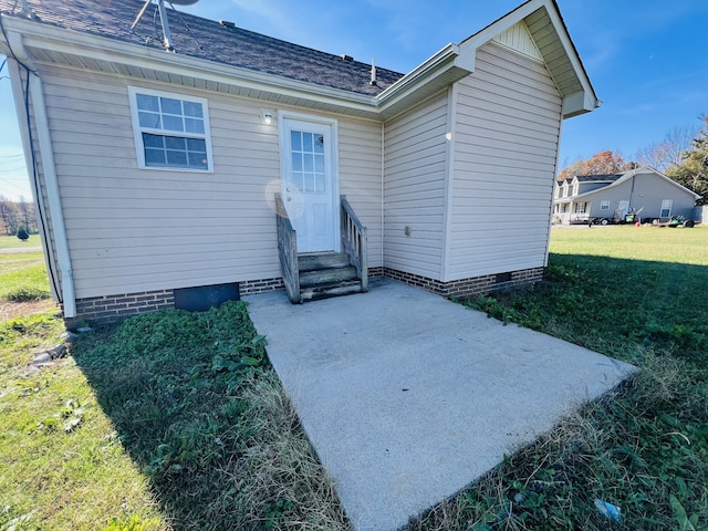 rear view of house with a yard and a patio