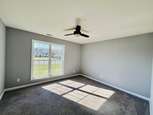 carpeted spare room with ceiling fan