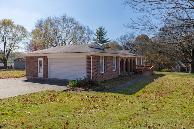 view of side of home featuring a lawn and a garage