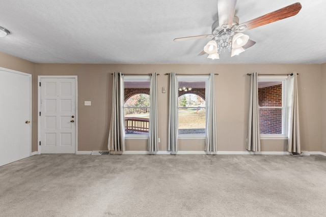 spare room with ceiling fan, carpet floors, and a textured ceiling