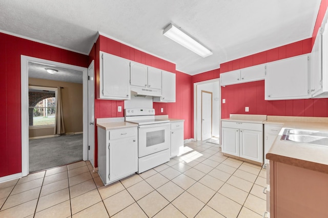 kitchen with light tile patterned floors, white cabinetry, white range with electric stovetop, and sink