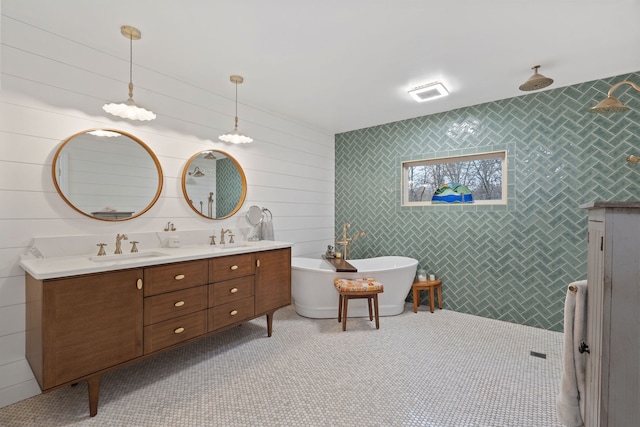 bathroom featuring a bathtub, vanity, and tile walls