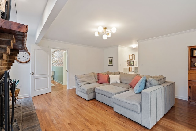 living room with crown molding, light hardwood / wood-style flooring, and a brick fireplace