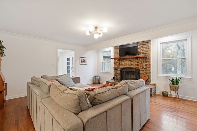 living room featuring crown molding, light hardwood / wood-style flooring, and a brick fireplace