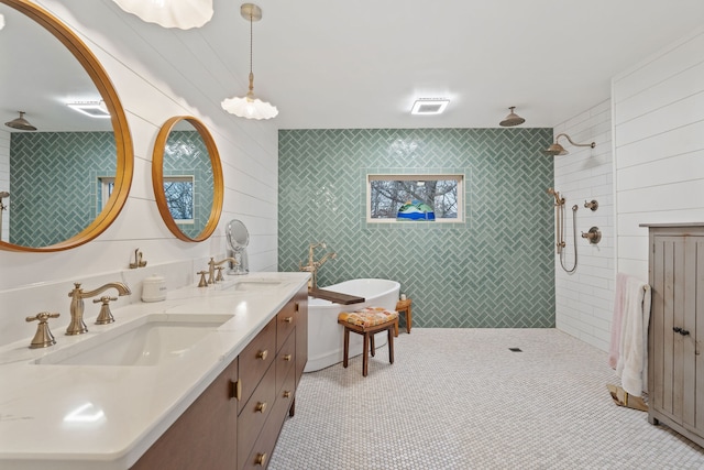 bathroom with tile patterned flooring, vanity, tile walls, and independent shower and bath