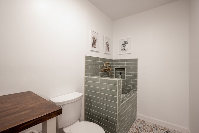 bathroom featuring tile patterned floors, a shower, and toilet