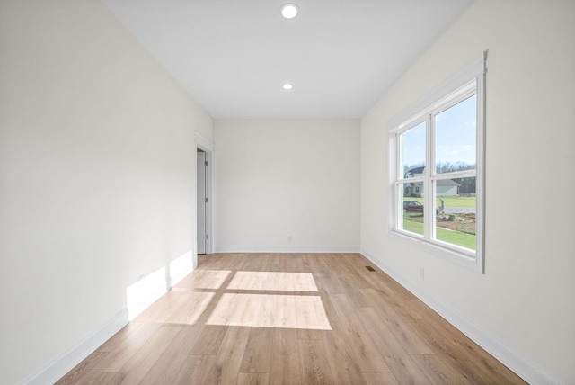 spare room featuring light hardwood / wood-style floors