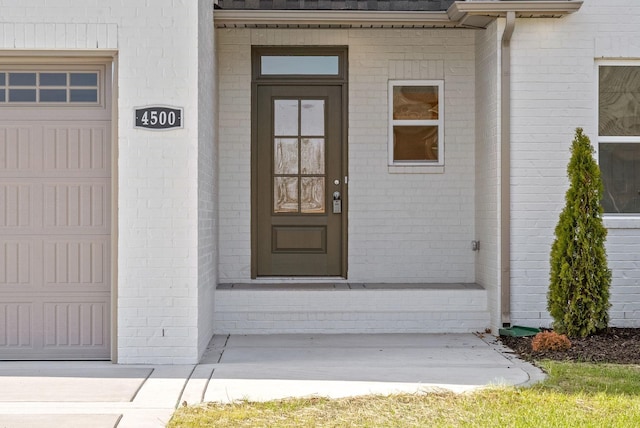 view of exterior entry with a garage