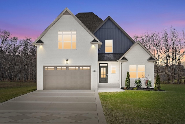 view of front of house with a yard and a garage