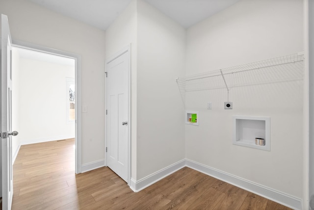 clothes washing area with hookup for an electric dryer, hookup for a washing machine, and hardwood / wood-style flooring