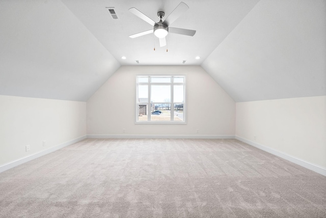 additional living space featuring ceiling fan, light colored carpet, and lofted ceiling