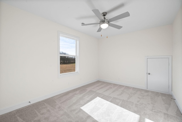 carpeted spare room with ceiling fan